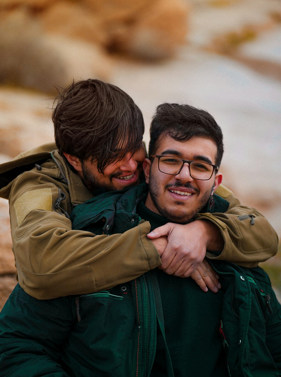 Two friends embracing warmly outdoors